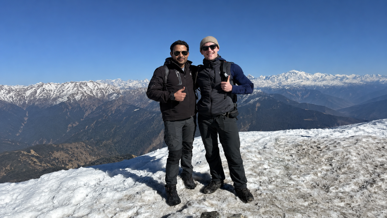 Participants enjoying a Himalayan yoga retreat mountain trek with breathtaking snow-covered Himalayan peak views