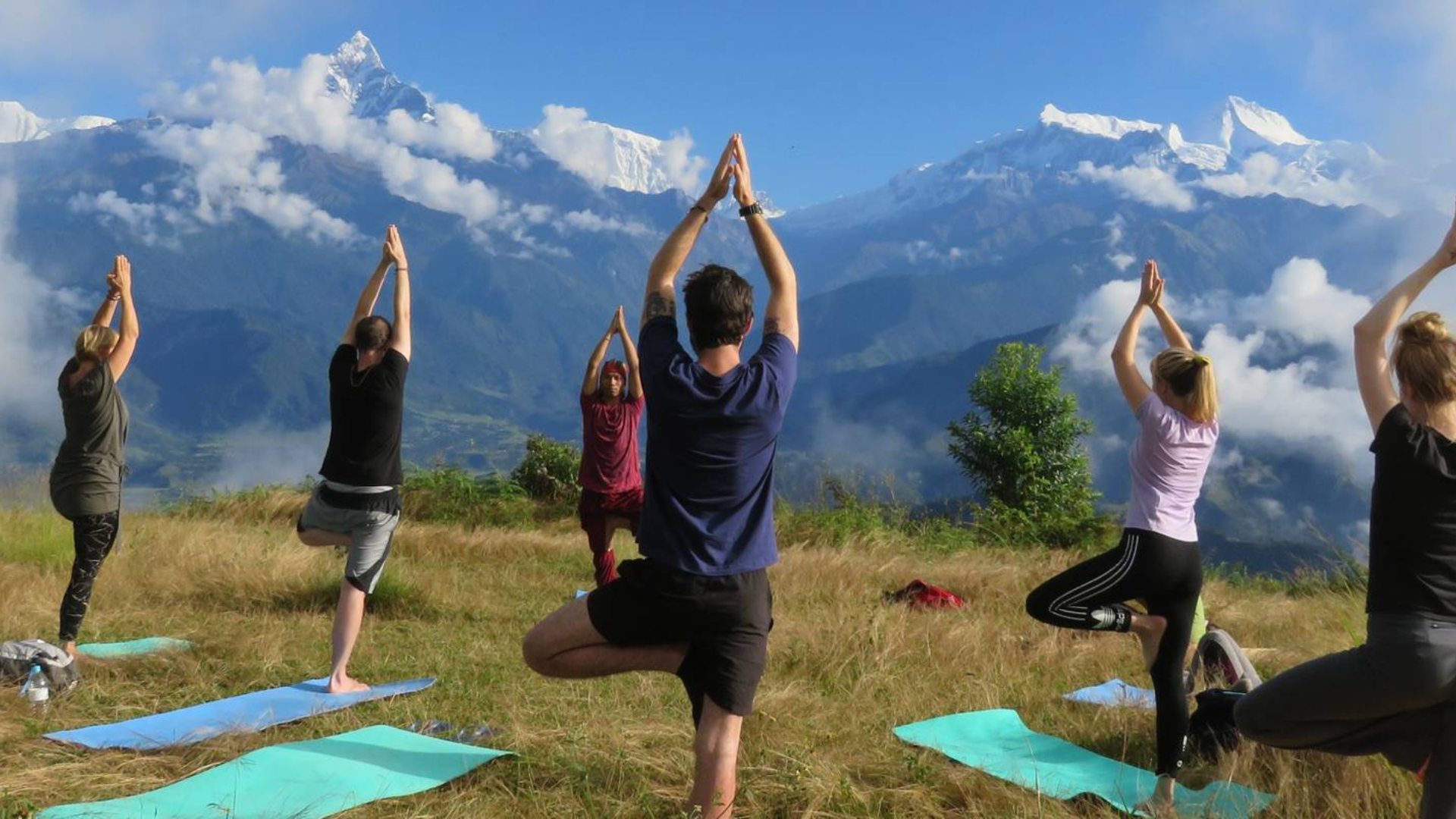 Group meditation beside Deoria Tal lake during yoga retreat