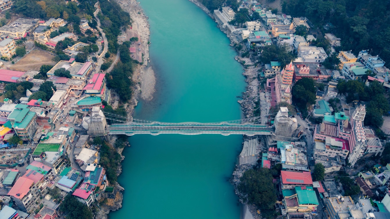 Bajrang Setu glass bridge over Ganges river in Rishikesh with tourists walking on transparent floor