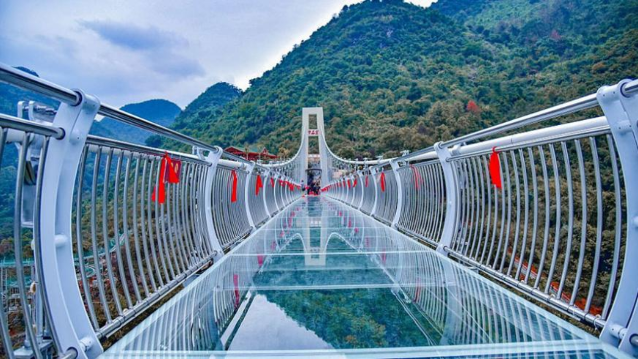 Bajrang Setu glass bridge photos showing tourists walking above the Ganges River in Rishikesh