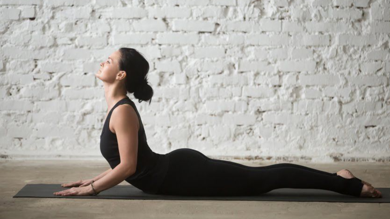 Person practicing Cobra Pose to strengthen heart muscles naturally
