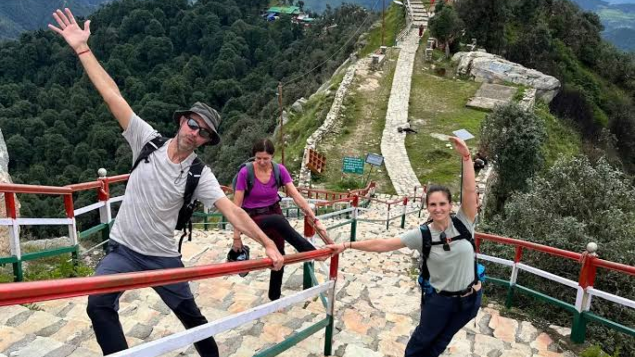 Trekkers walking on a Himalayan forest trail near Rishikesh during the hiking yoga retreat