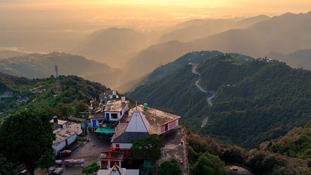Aerial view of Kunjapuri Temple Rishikesh perched on the hilltop surrounded by Himalayan forest and mountain ridges