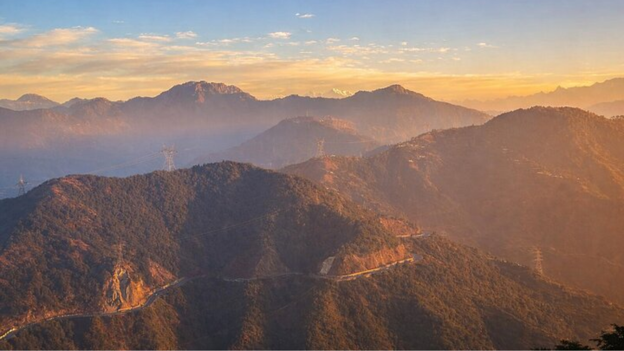 Kunjapuri Temple top view showing Himalayan mountain range and valley below on a clear morning