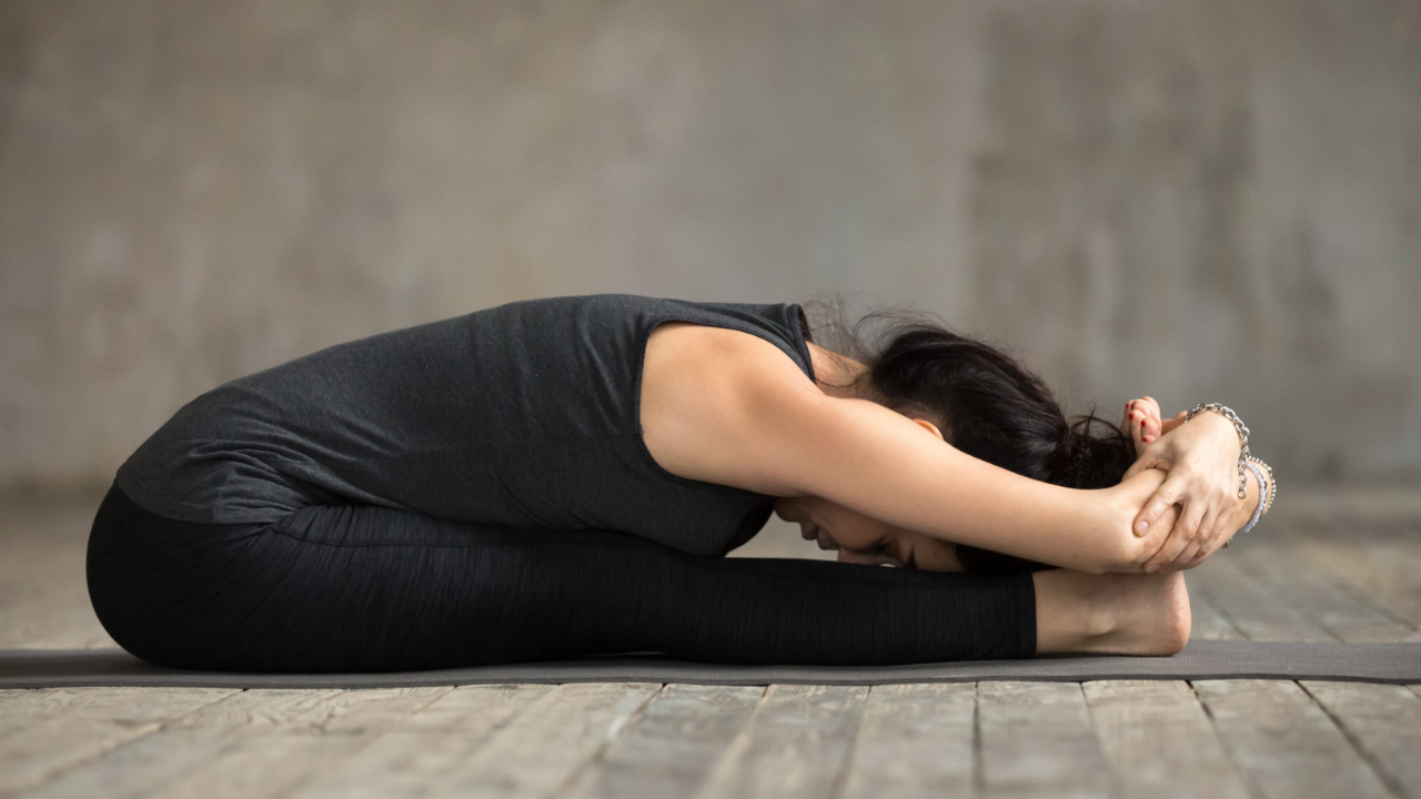 Paschimottanasana seated forward fold yoga pose benefits