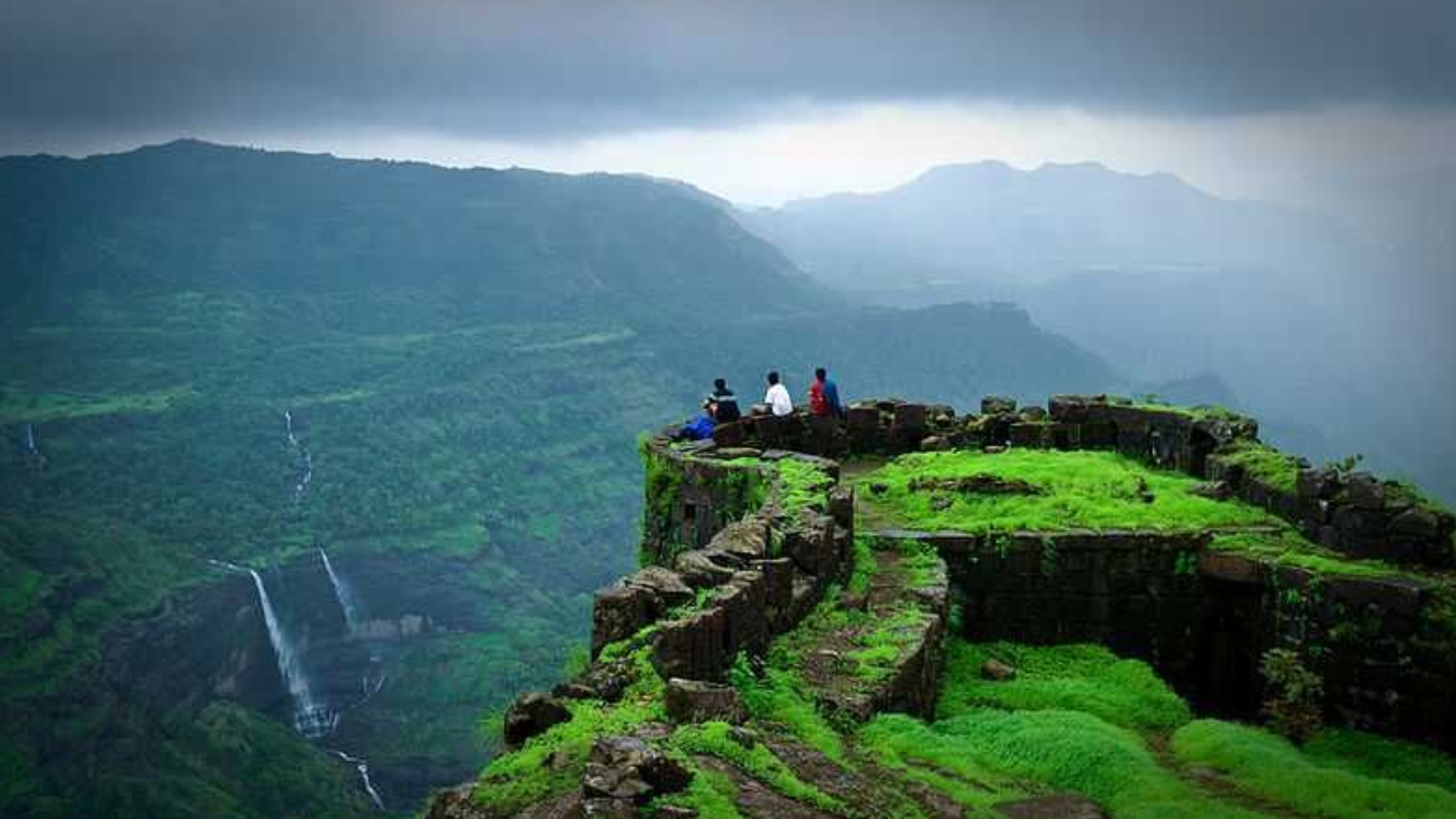 Lush green Rajmachi Fort during monsoon with misty mountains in Maharashtra