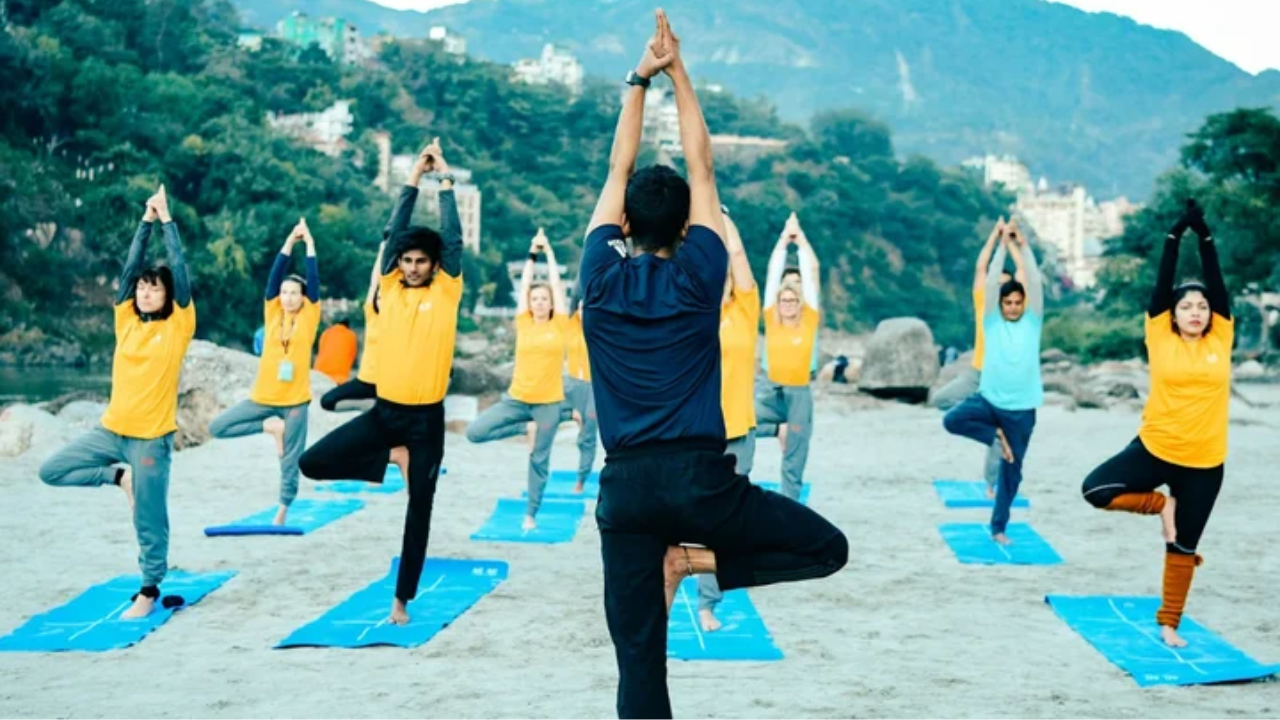 Solo travelers participating in a morning yoga class together at a retreat in Rishikesh building community and connections