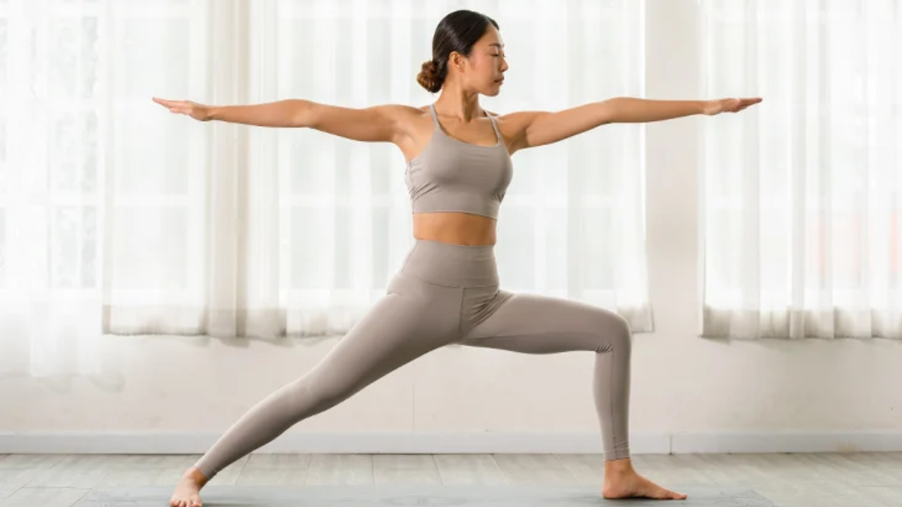 Woman doing Warrior II pose (Virabhadrasana II) showing proper alignment and form