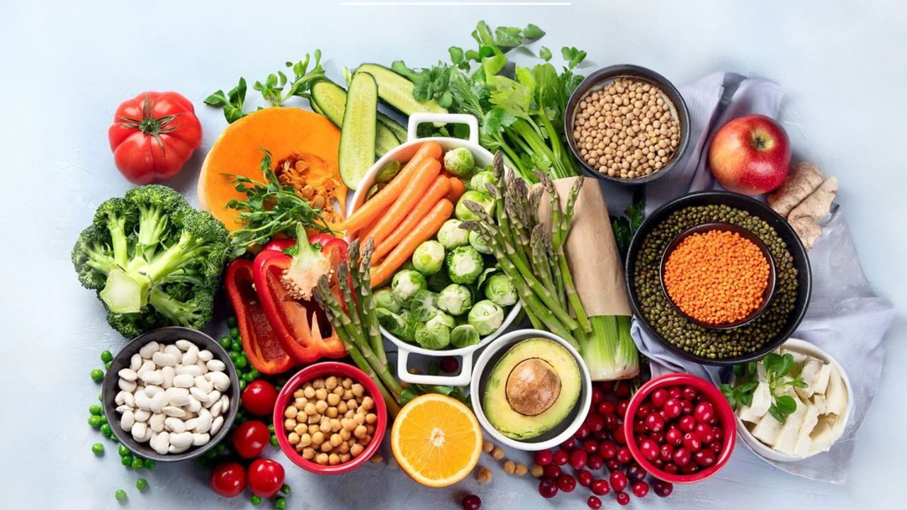 Healthy sattvic vegetarian food served at a yoga retreat in Rishikesh — fresh vegetables, dal, rice, and fruits on a wooden table